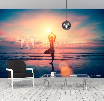 Bild på Silhouette yoga girl on the background of stunning sea and sunset Fitness meditation and healthy lifestyle